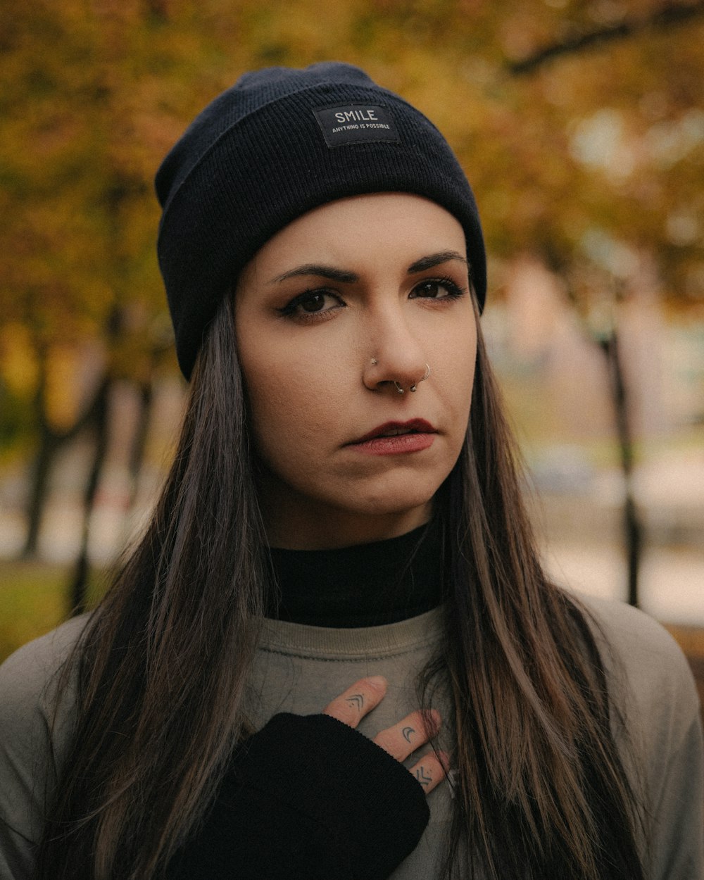 a woman with long hair wearing a beanie