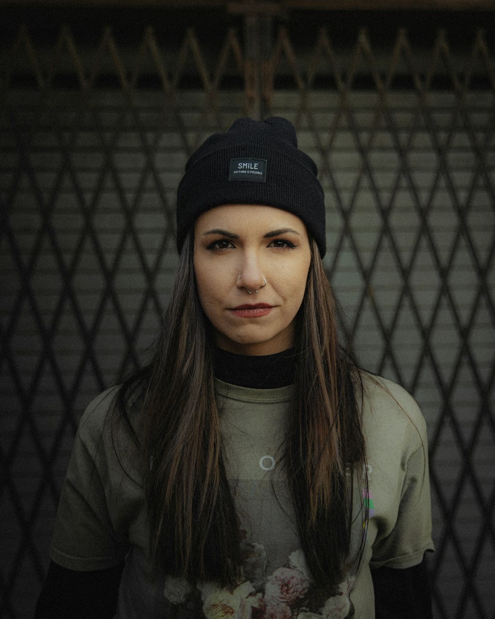 a woman with long hair wearing a beanie