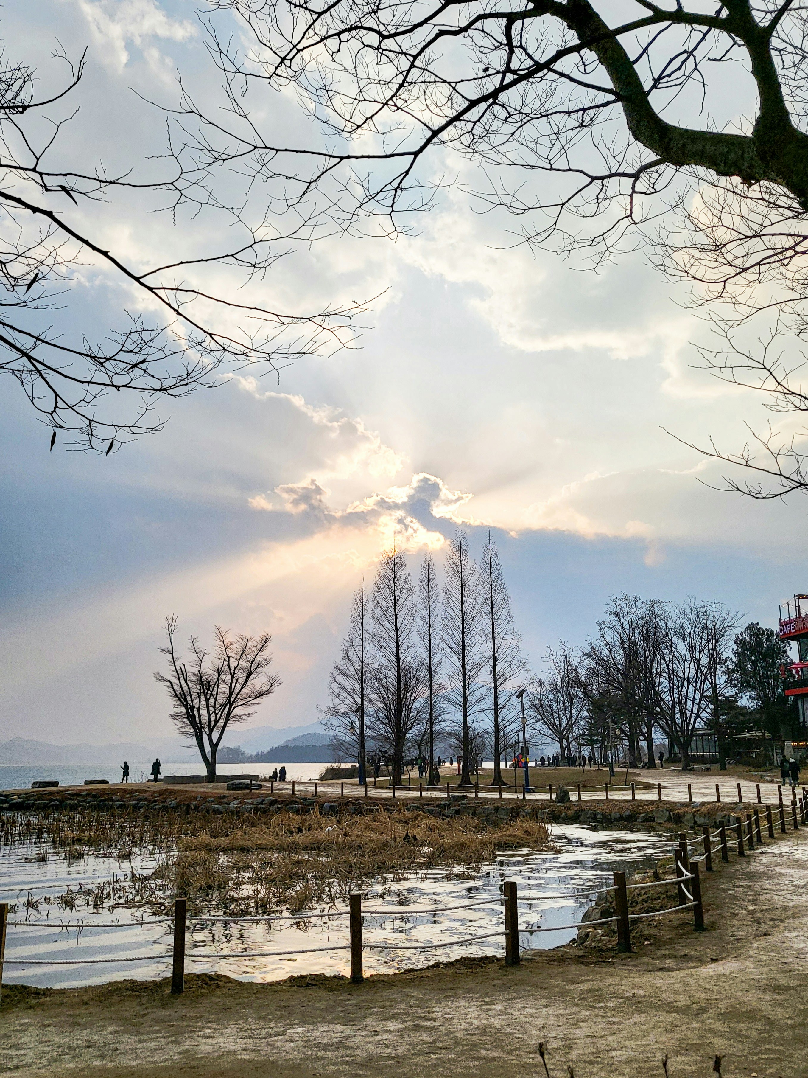 the sun is shining through the clouds over the water