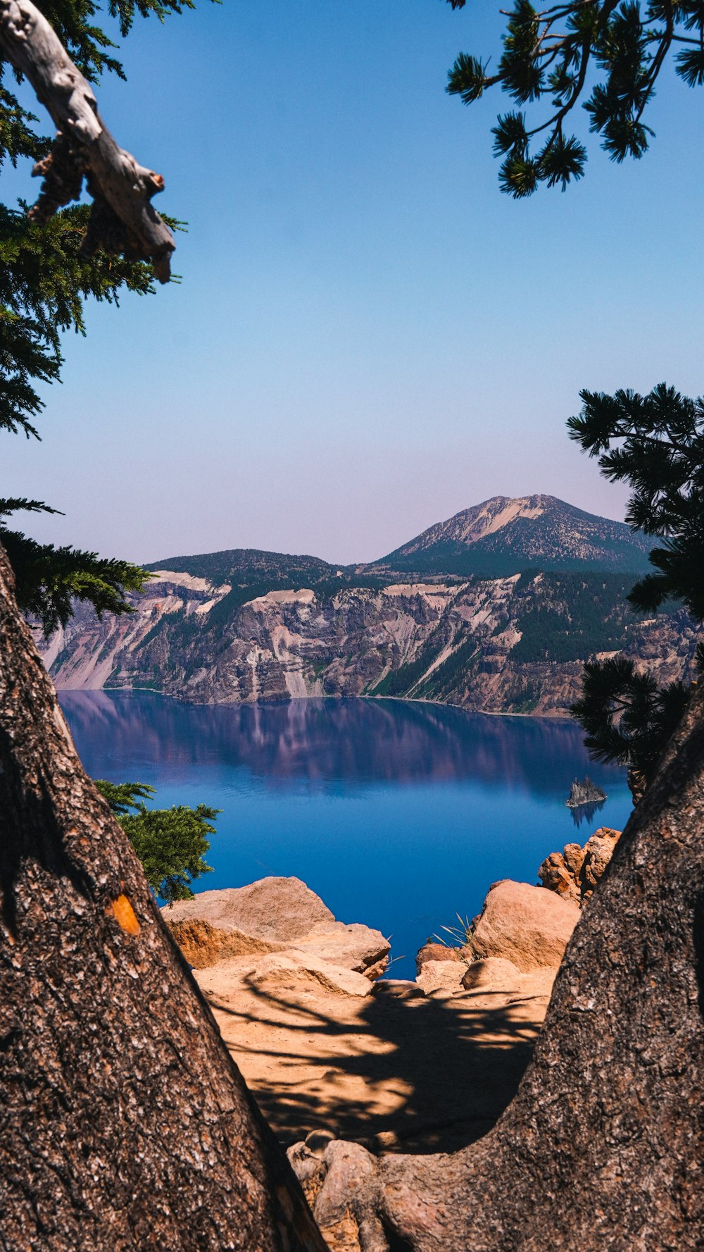 a view of a lake through some rocks