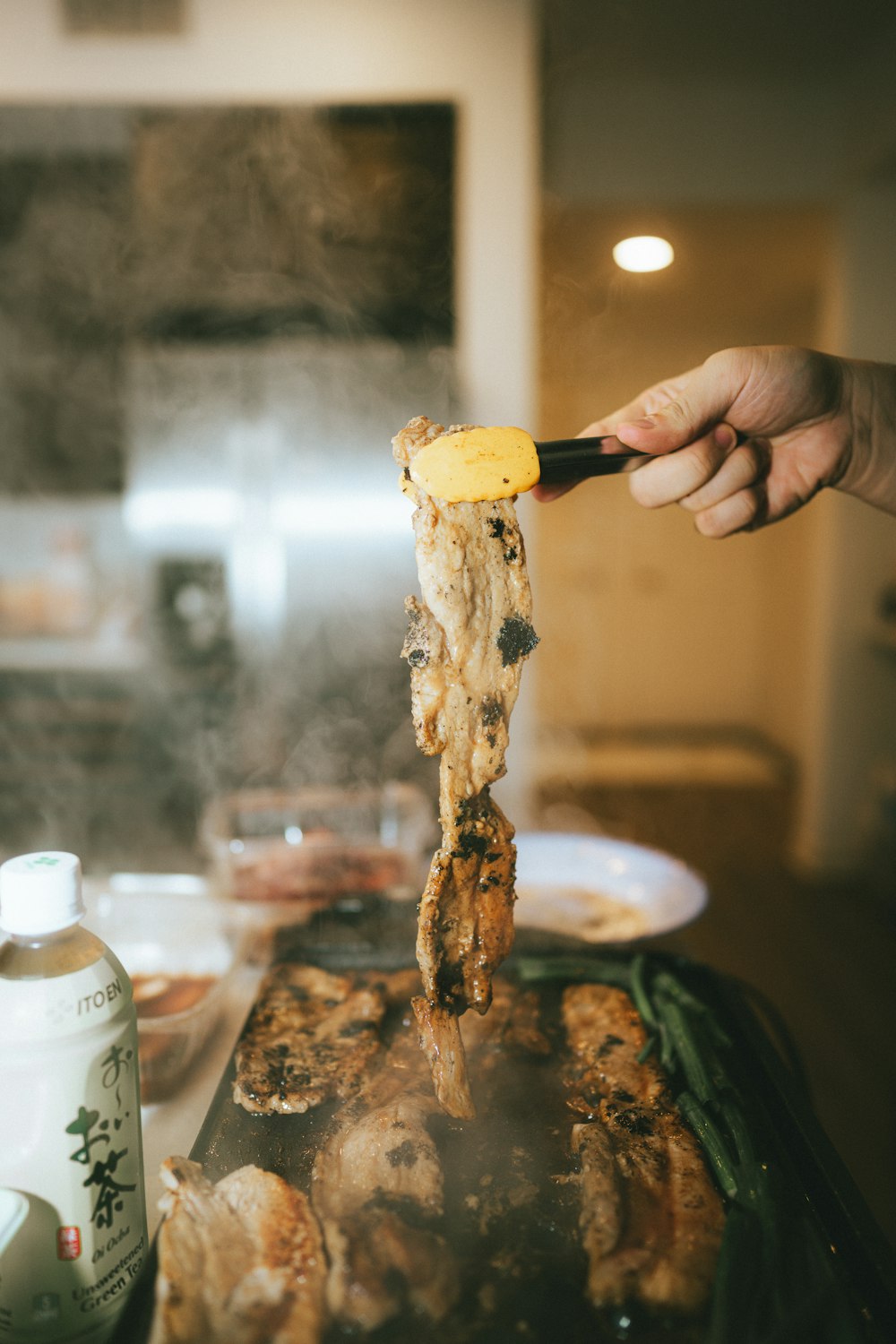 a person is cooking food on a grill