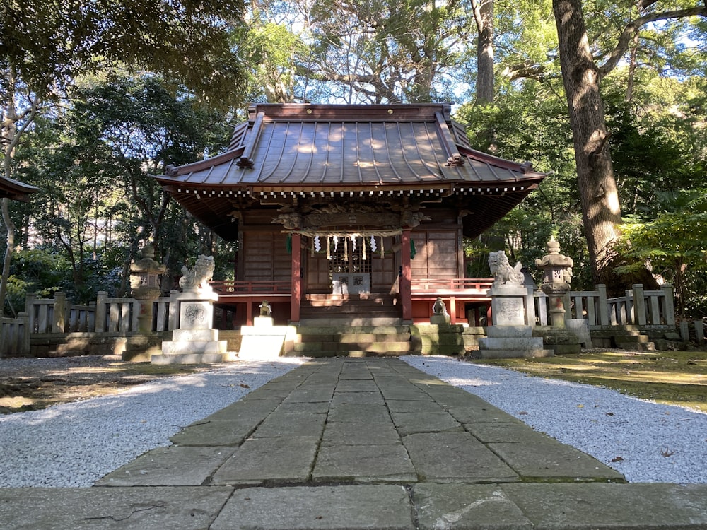 a small wooden building in the middle of a park