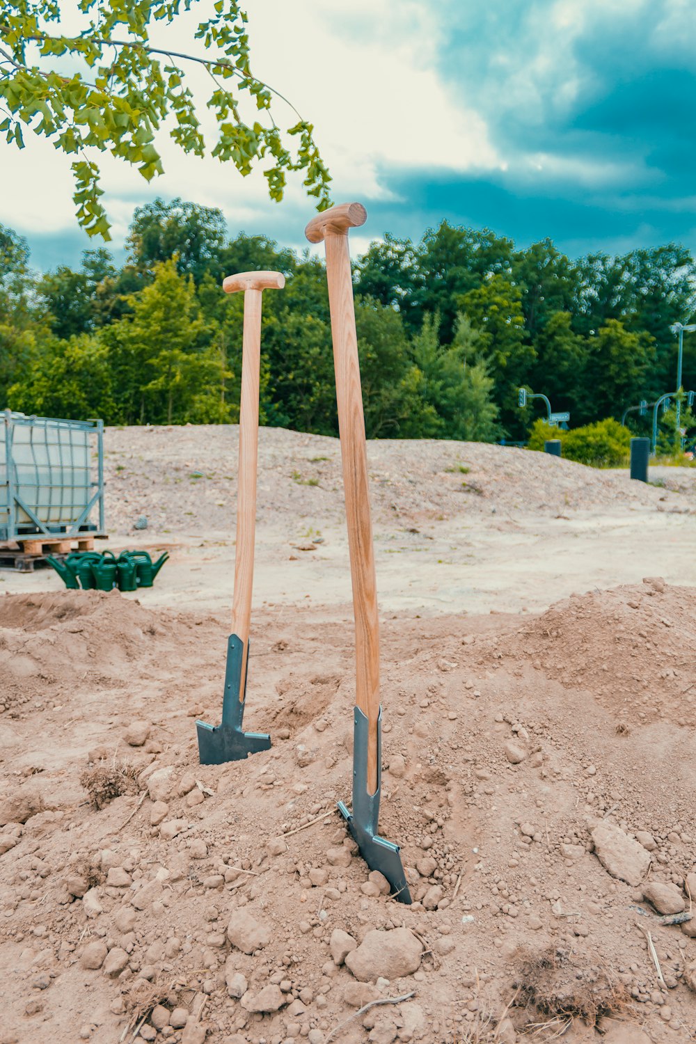 a couple of shovels that are in the dirt