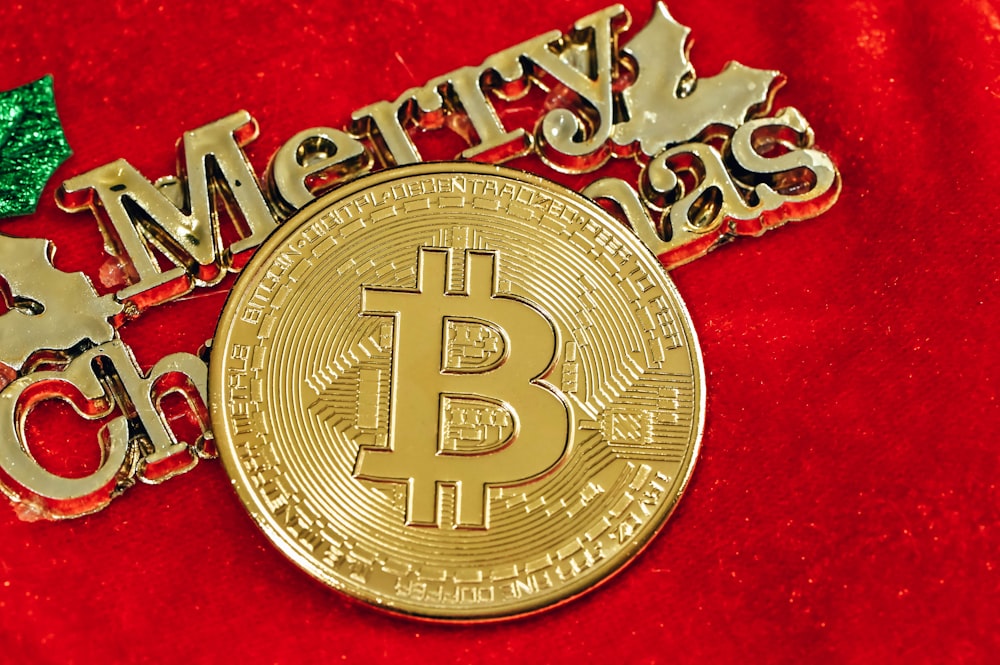 a golden bitcoin sitting on top of a red blanket