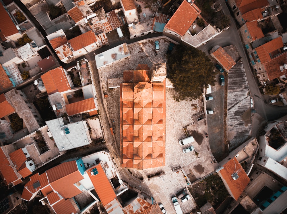 an aerial view of a city with orange roofs