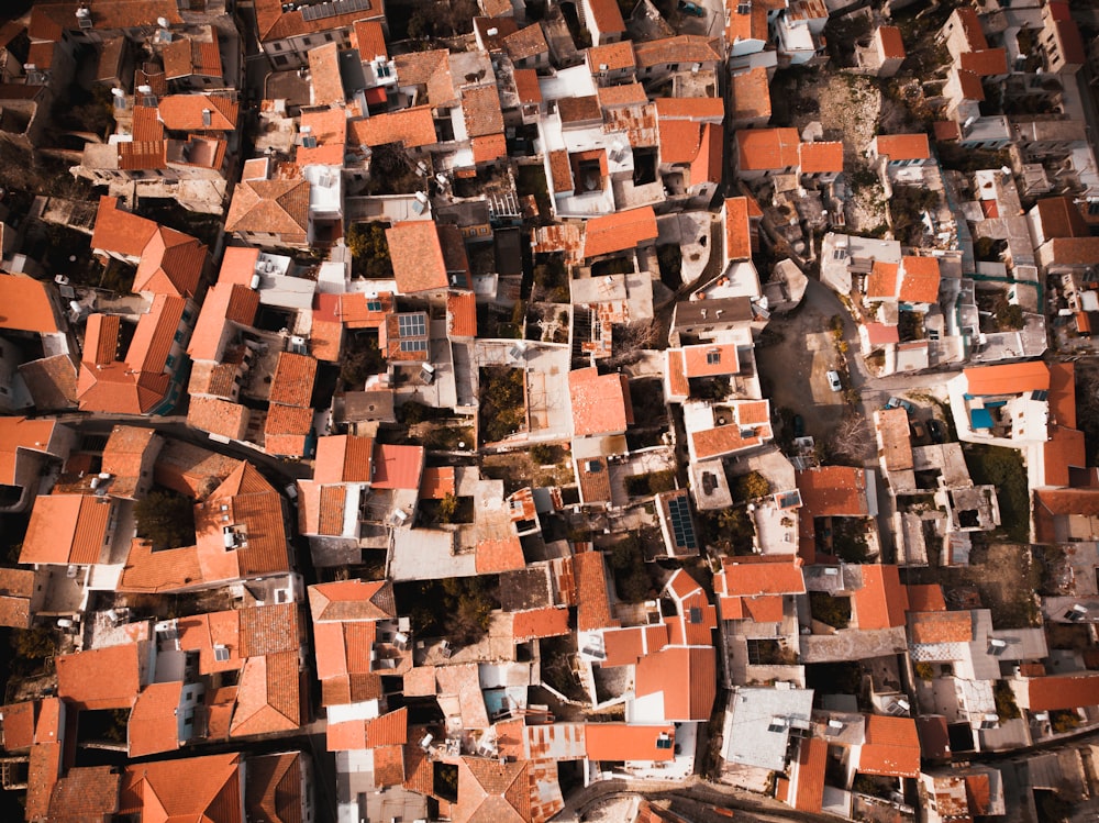 an aerial view of a city with red roofs