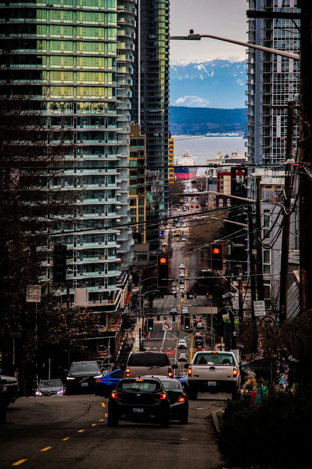 a city street filled with lots of traffic next to tall buildings