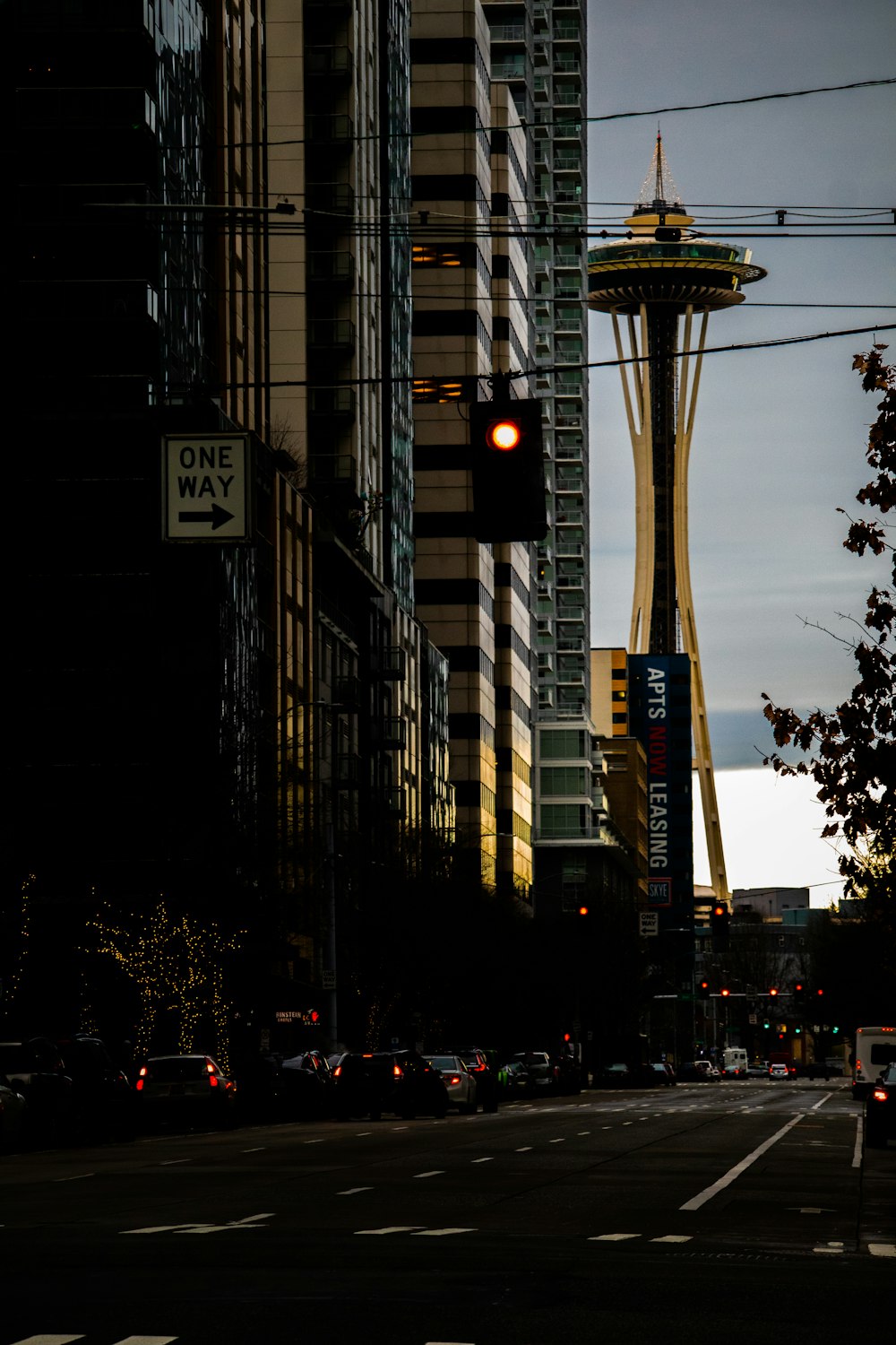 a traffic light on a city street with tall buildings in the background