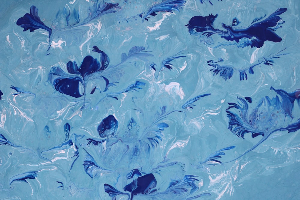 a painting of blue flowers in water
