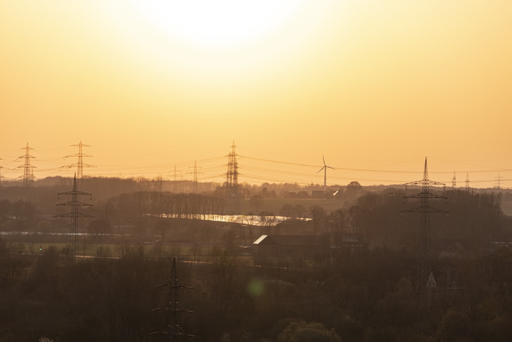 the sun is setting over a rural area