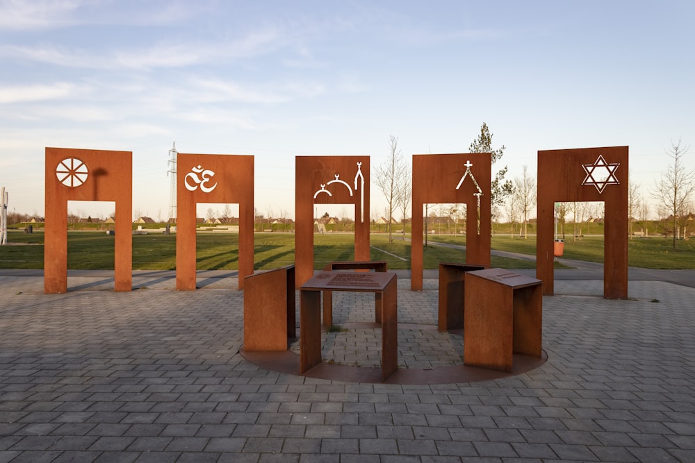 a group of wooden sculptures sitting on top of a sidewalk