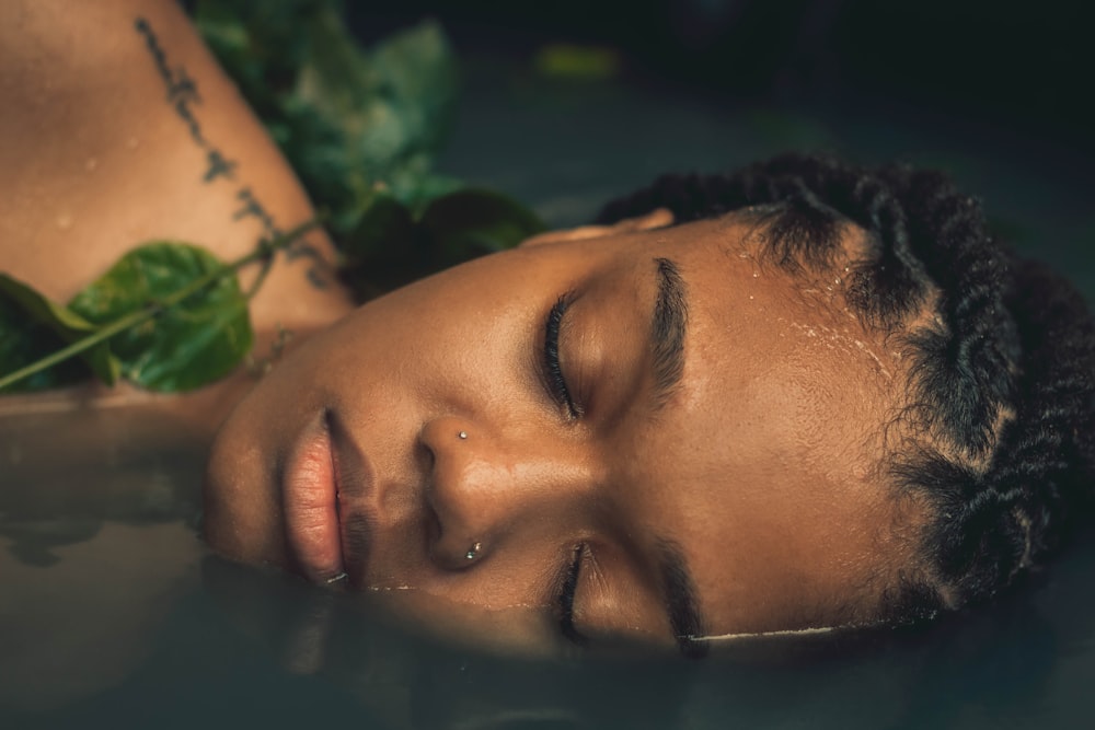 a close up of a person laying in a pool of water