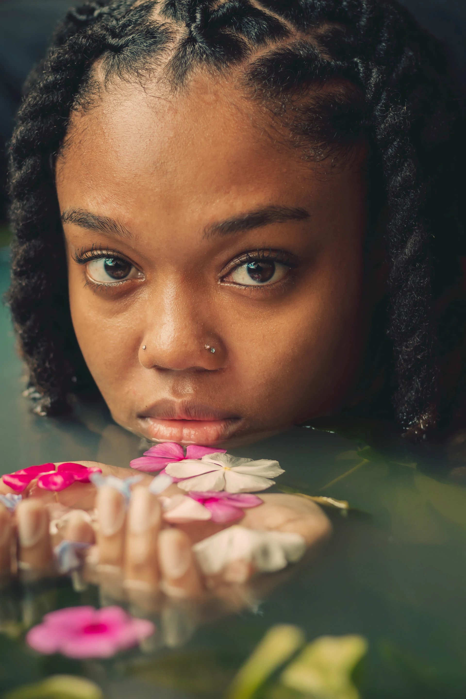 a young girl is holding flowers in her hands