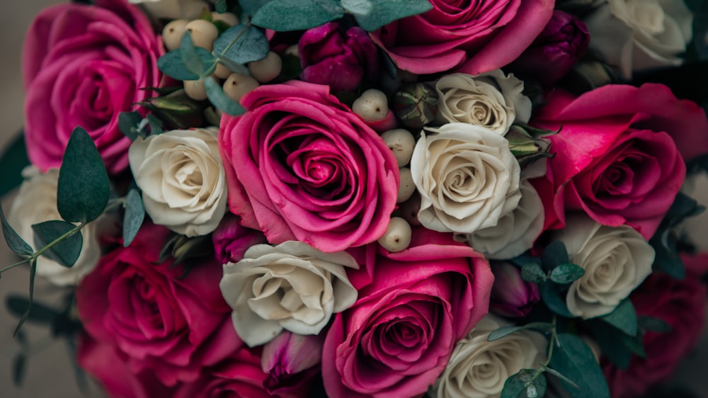 a bouquet of pink and white roses