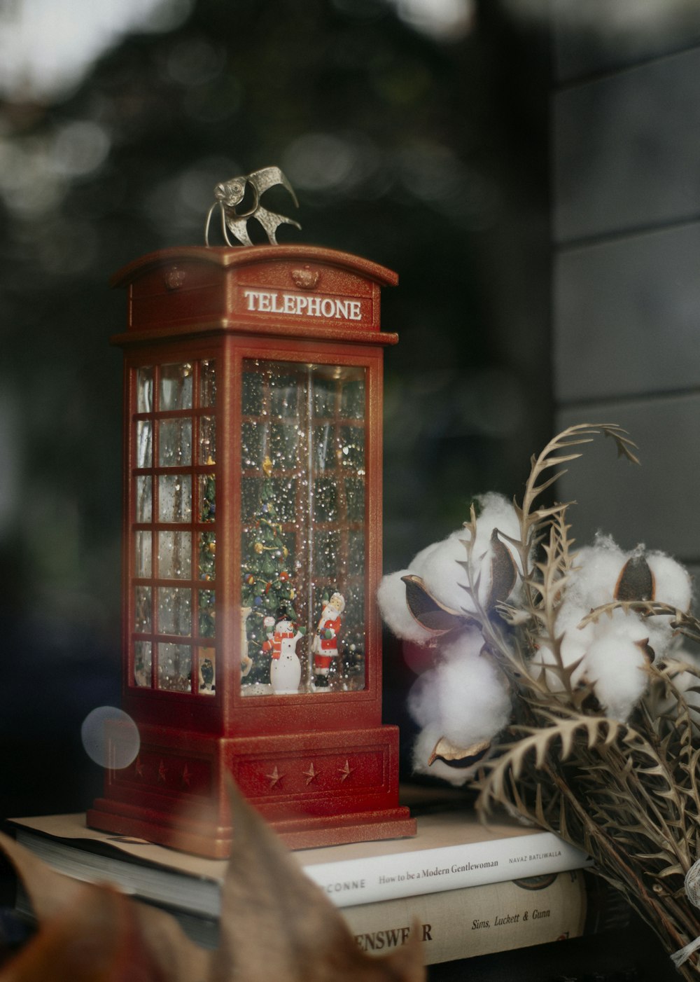 a telephone booth with cotton in front of it