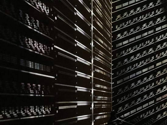 A sleek server rack with softly glowing lights in a dim room representing company infrastructure.