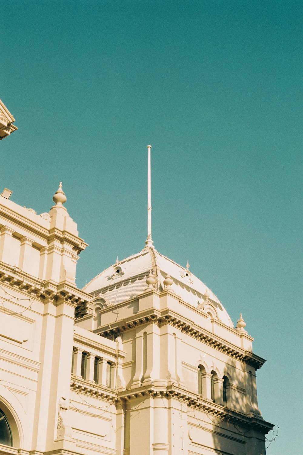 a large white building with a flag on top of it