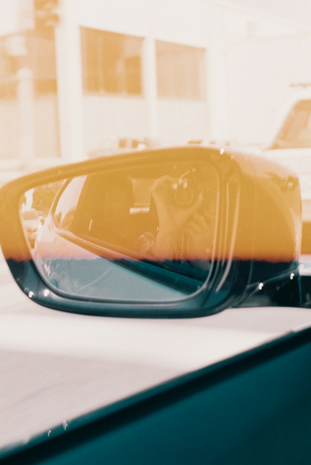 a rear view mirror sitting on the side of a car