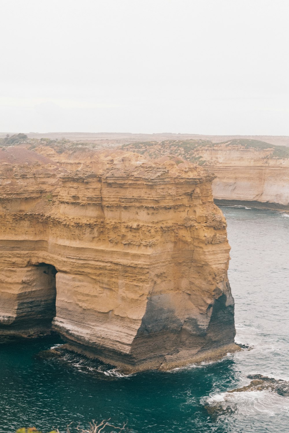 a large rock formation near a body of water