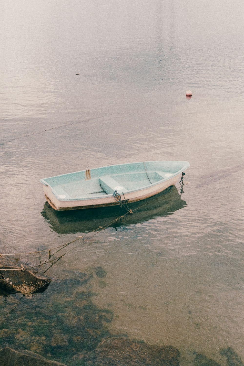 a small boat floating on top of a body of water