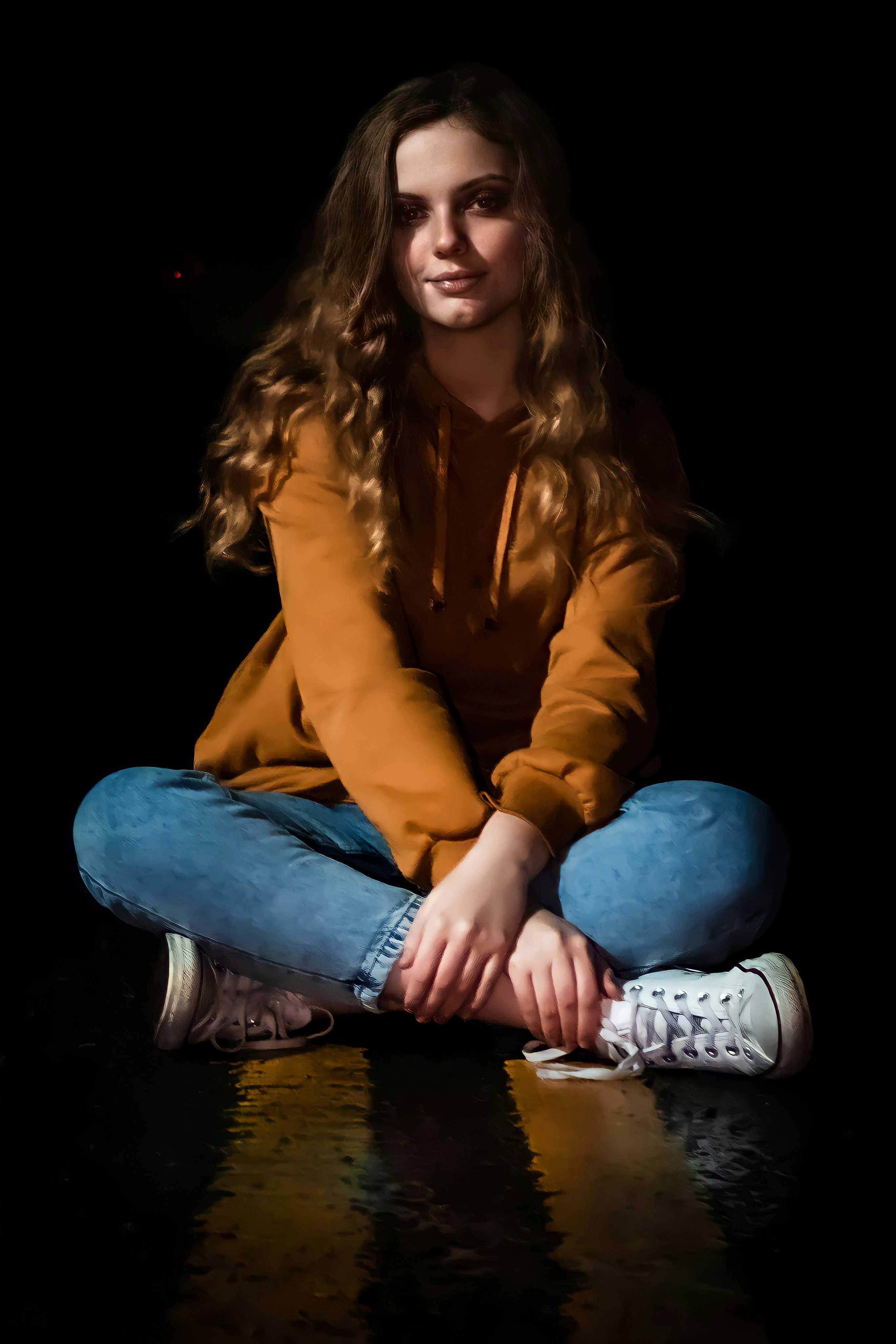 a woman sitting on the floor with her legs crossed