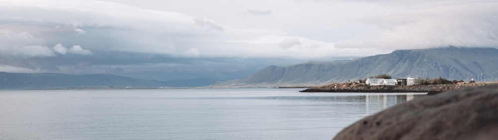 a body of water with a mountain in the background