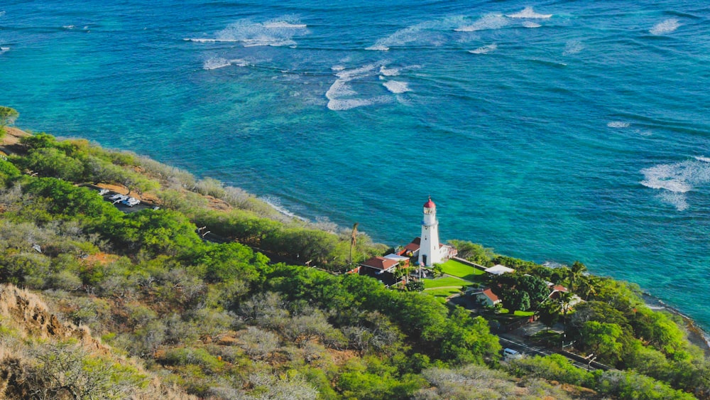 a lighthouse on a cliff overlooking the ocean