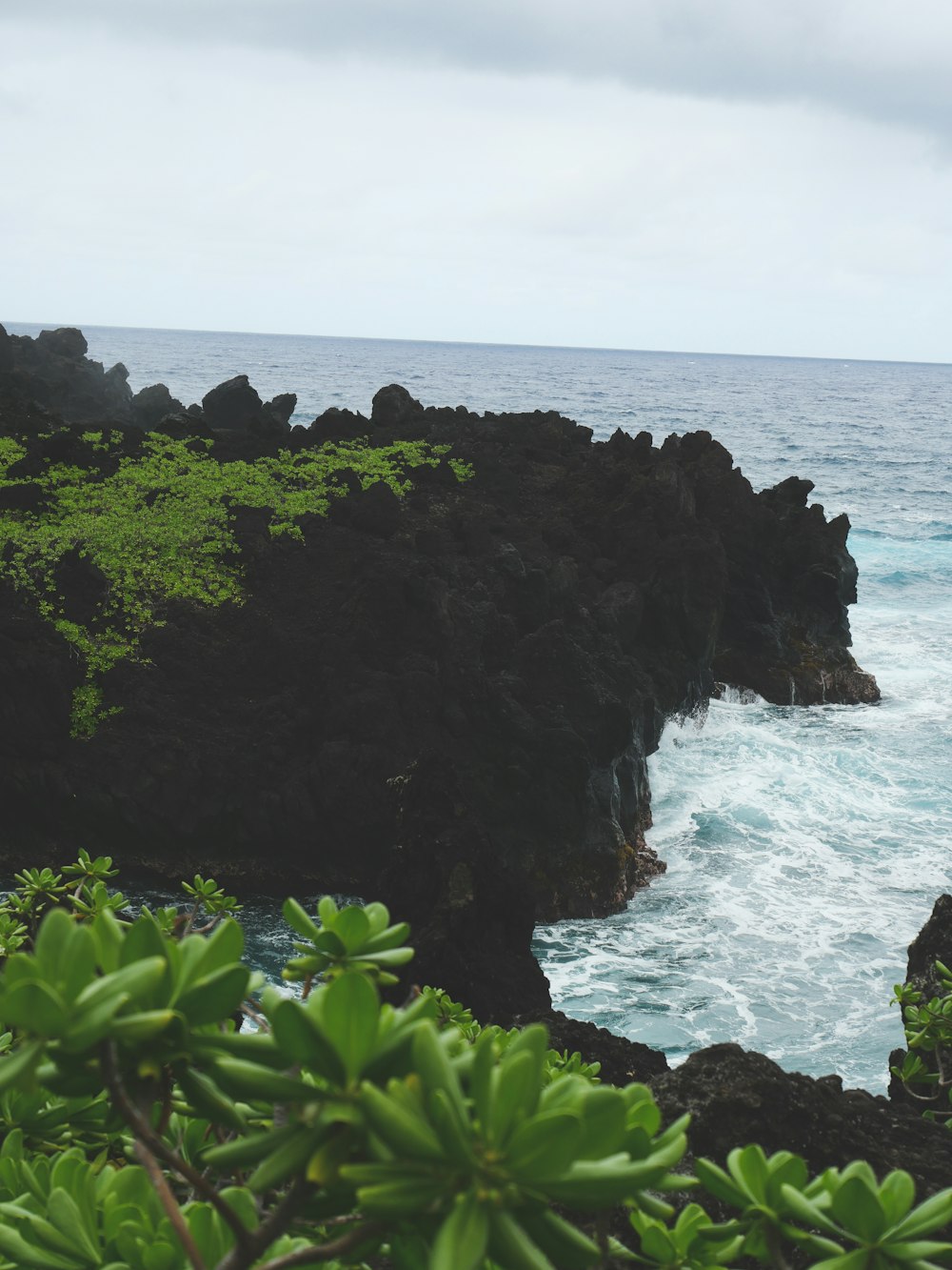 a view of the ocean from a rocky cliff