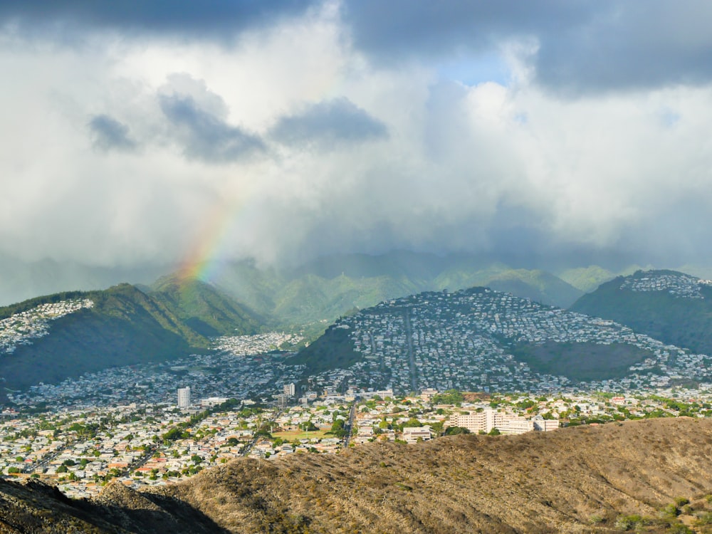 a view of a city with a rainbow in the sky