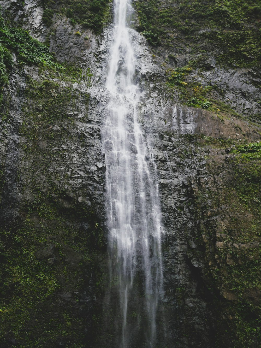 a tall waterfall with lots of water coming out of it