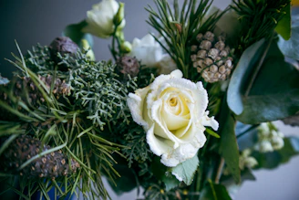 Intimate baptism floral arrangement with natural textures and heartfelt details.