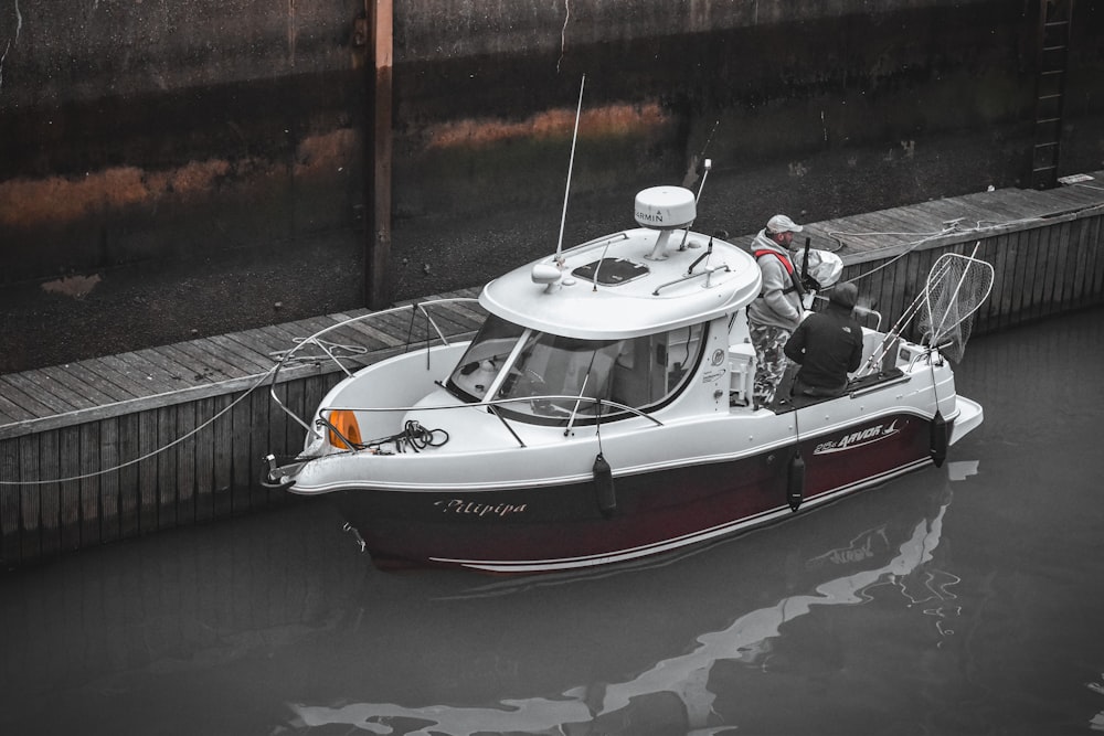 a white and red boat in a body of water