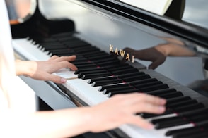 a person playing a piano with their hands