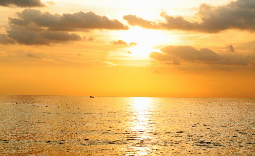 a large body of water under a cloudy sky