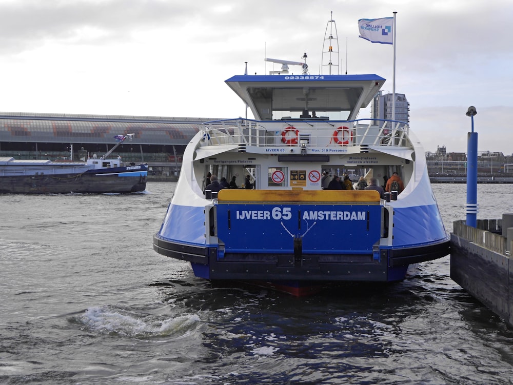 a blue and white ferry boat in the water