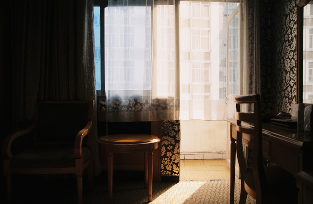 a room with a chair, desk and a window