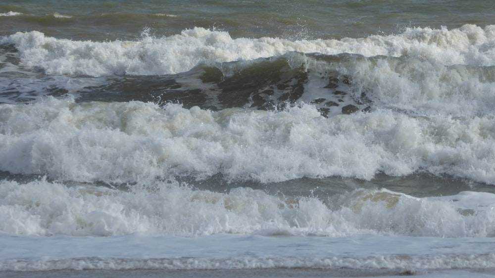 a person riding a surfboard on a wave in the ocean