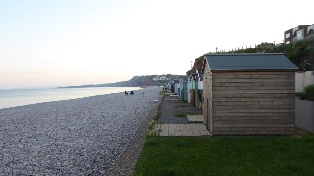 a row of beach huts next to a body of water