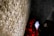 Carved names are visible on a stone memorial, with red poppy wreaths placed at its base, suggesting a tribute or remembrance setting.