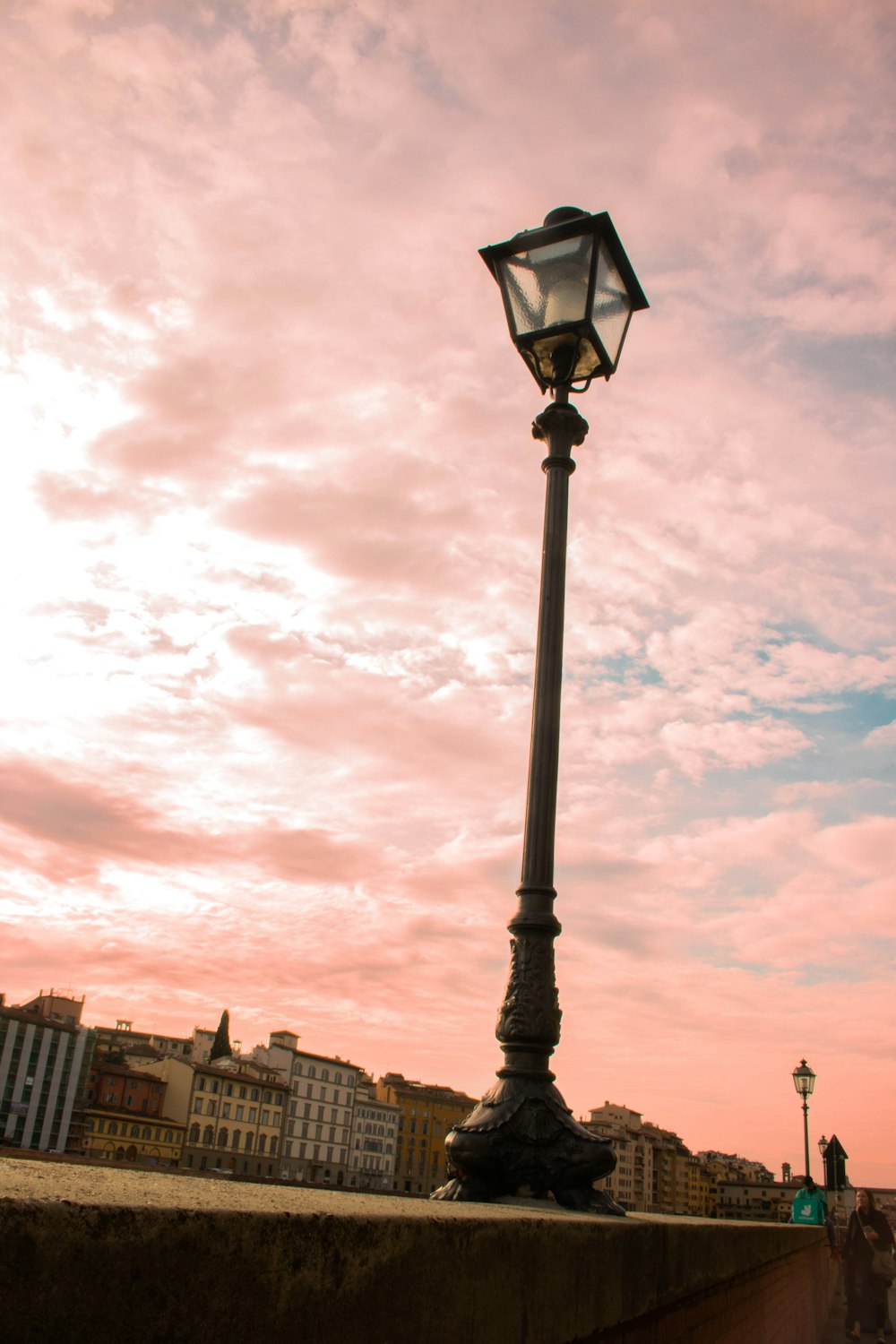 a street light sitting on the side of a road