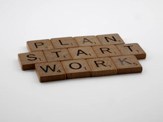a scrabble of scrabble tiles spelling the words plan, start,