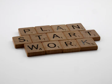 a scrabble of scrabble tiles spelling the words plan, start,