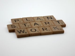 scrabble tiles spelling plan, start, and work