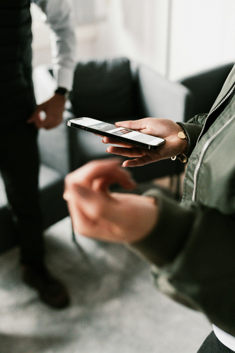 a person holding a cell phone in their hands