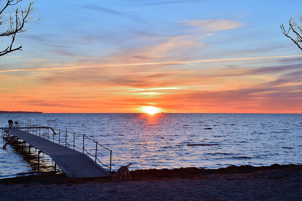 the sun is setting over a body of water