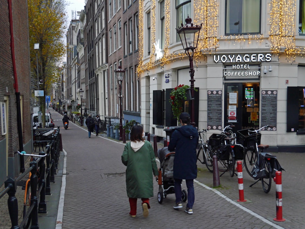 a couple of people that are walking down a street