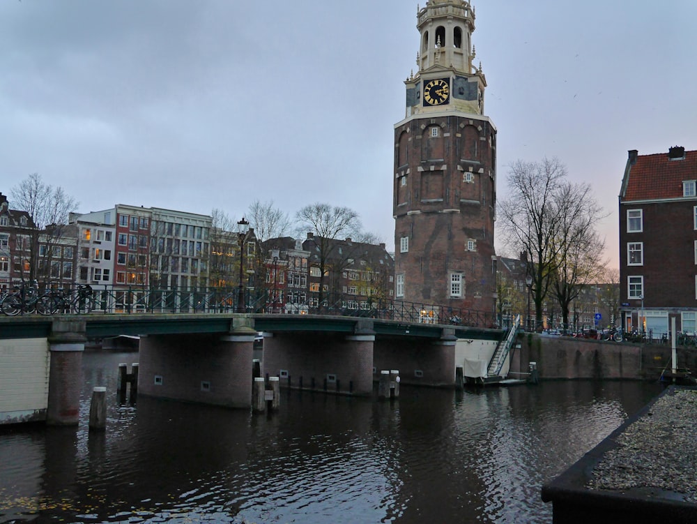 a large clock tower towering over a river