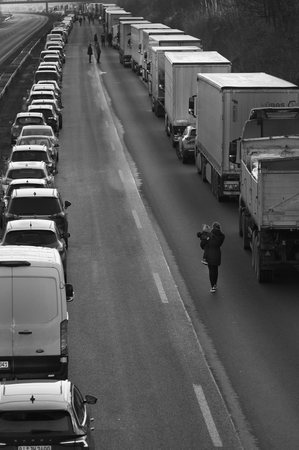 a black and white photo of traffic on a highway