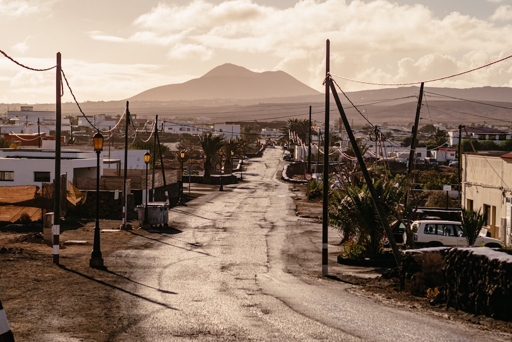 a dirt road with a mountain in the background