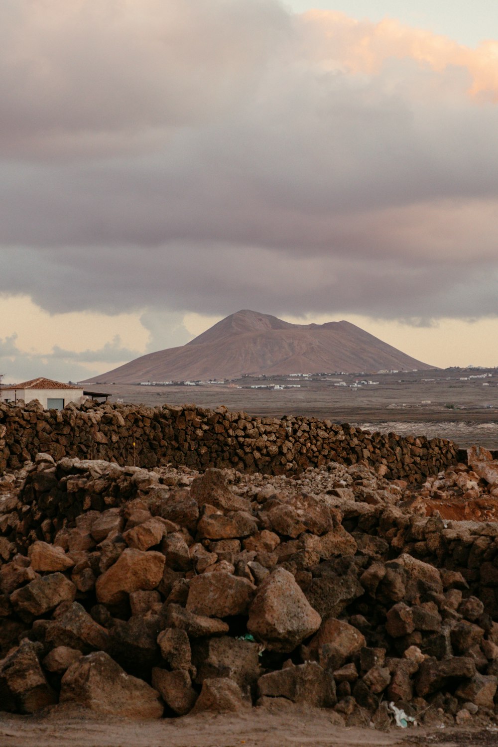 a large pile of rocks sitting next to a mountain